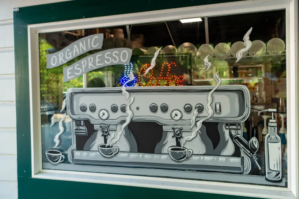 Image of an espresso machine painted on the window glass