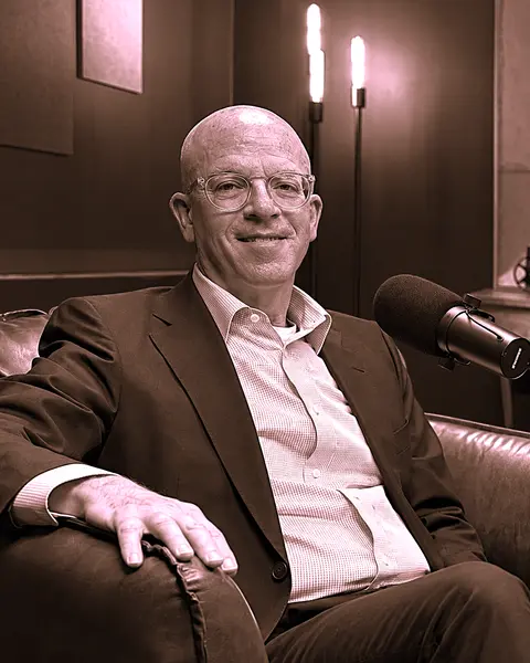 Dr. Lee Scheinbart seated beside a microphone in a podcast studio