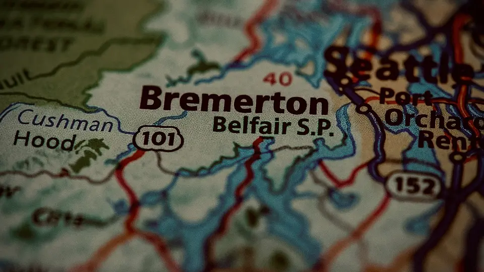 Moody Map of Bremerton Vintage style close-up of a map showing Bremerton and Belfair State Park in Washington State, with soft cinematic lighting and rich Pacific Northwest tones.